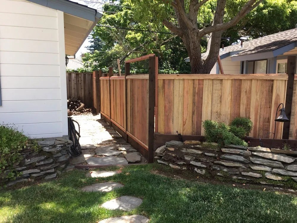 Retaining wall and wood fence by Meza's Fence