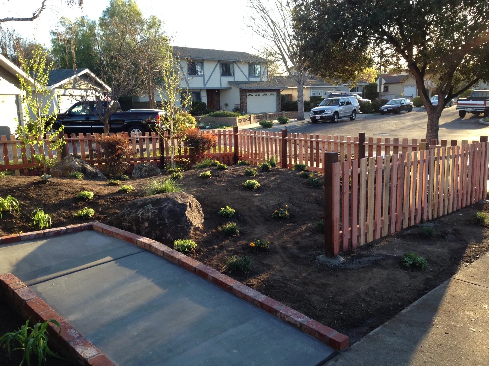 Stained redwood picket fence built by Meza's Fence