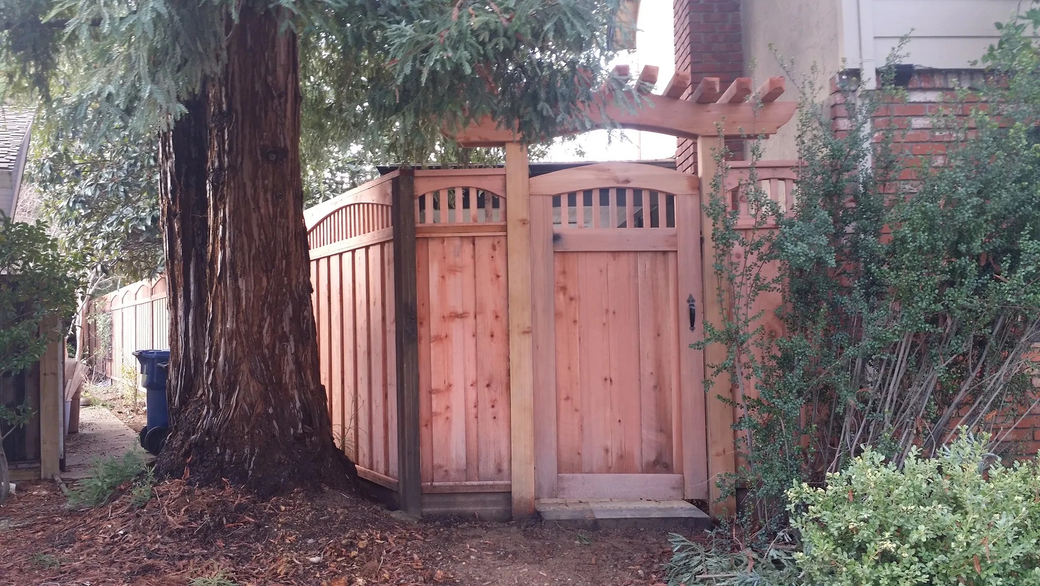 Wood arbor and gate built by Meza's Fence