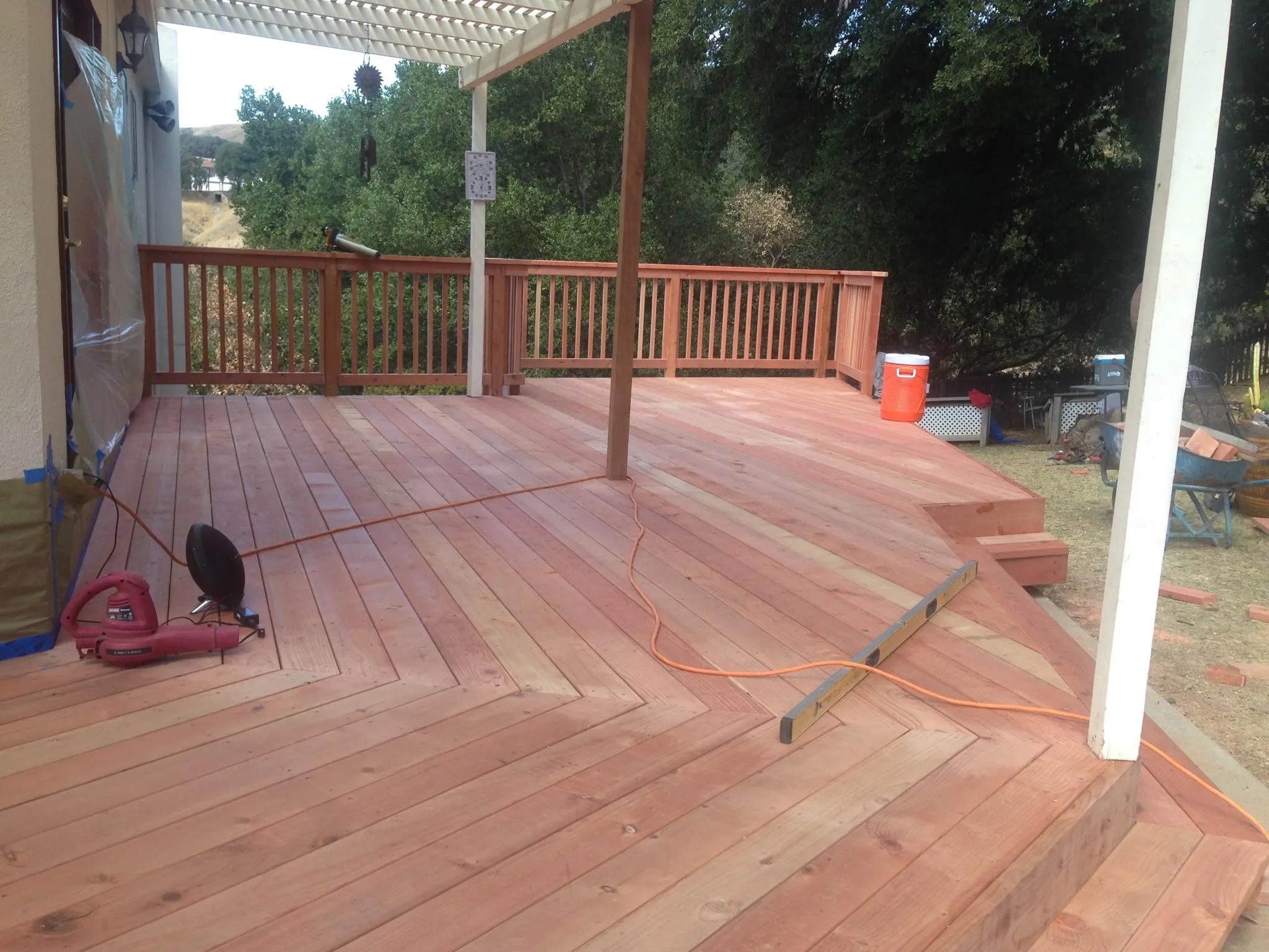 Redwood deck with chevron boards by Meza's Fence